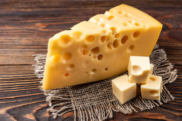 Cheese on dark wooden background. 