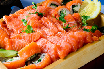 Salmon raw sashimi on brown Japanese traditional dish on black table. Close up.