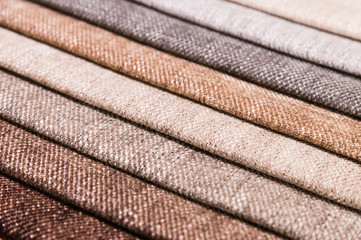 Close-up diagonal lines of textile upholstery in samples to select the color and fabric of the furniture. Abstract multicolored background
