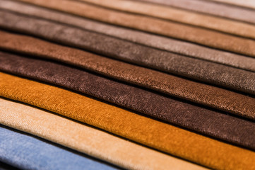Close-up diagonal lines of textile upholstery in samples to select the color and fabric of the furniture. Abstract multicolored background