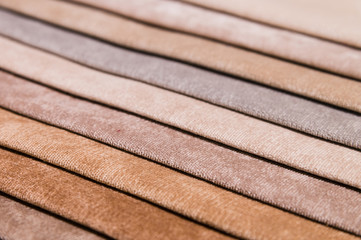 Close-up diagonal lines of textile upholstery in samples to select the color and fabric of the furniture. Abstract multicolored background