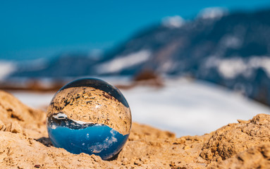 Fototapeta na wymiar Crystal ball alpine winter landscape shot at Fieberbrunn-Tyrol-Austria