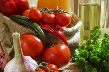 tomatoes in a linen bag with hot peppers, fresh herbs