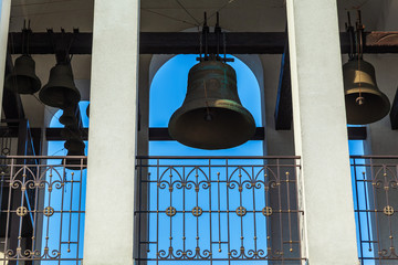 Obraz premium Big copper bell on the belfry of the bell tower of a Christian church temple at Easter.