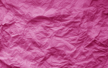 Crumpled sheet of paper in pink color.