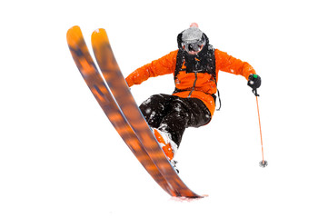 The athlete skier in the orange black suit does the trick on the back of the skis. real photo made...