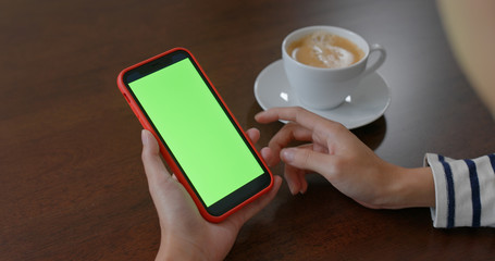 Woman use of mobile phone with green screen
