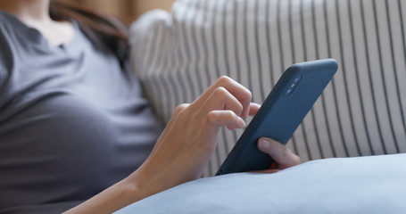 Woman use of mobile phone at home