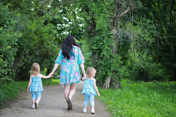 Naklejka na ściany i meble Mom with two daughters twins