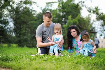 Fototapeta premium Mom with two daughters twins
