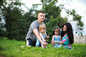 Fototapeta premium Mom with two daughters twins