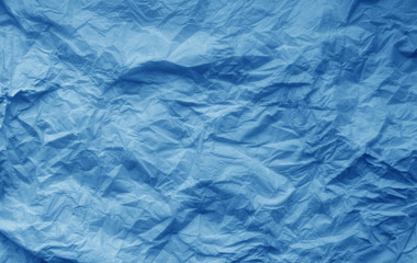 Crumpled sheet of paper in navy blue color.