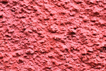  texture of red granular wall. grainy surface texture ; Close-up of a textured pink wall, showing rough surface and detail. Ideal for backgrounds, design, and texture concepts.