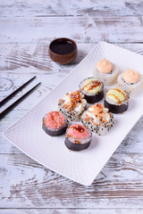 Sushi rolls assortment on a white ceramic plate