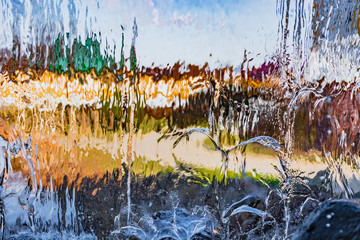Blurred image formed by a falling wall of water. A variety of water figures in the waterfall....