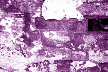 Old grungy brick wall texture in purple tone.