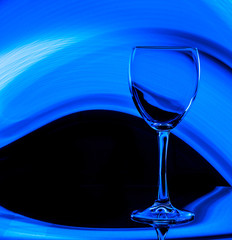 Wine glass on a black background with blue color