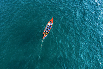 View from above, aerial view of a beautiful long tail boat sailing on a turquoise sea. Phi Phi Islands, Maya Bay, Krabi Province, Thailand.