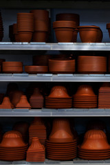 Many empty flower pots standing on the shelves