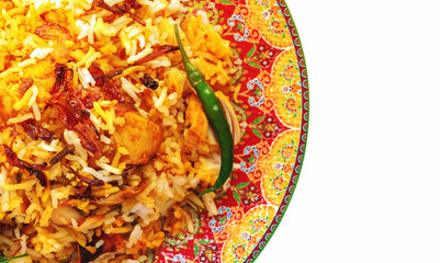 Halal Indian chicken Biryani served with yogurt tomato raita over white background. Selective focus.