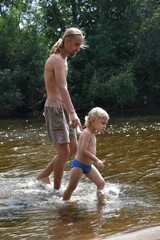 Fototapeta premium Father and son on the beach. Happy family. river.