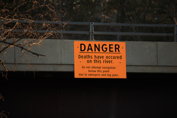 Danger sign over river