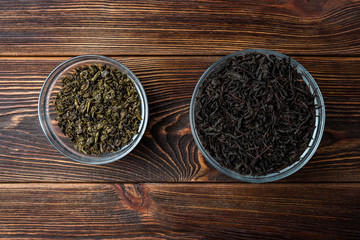 Black and green tea on dark wooden background.
