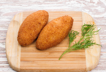 Kiev cutlets meat on wooden board