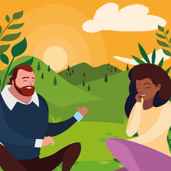 interracial young couple seated in the field