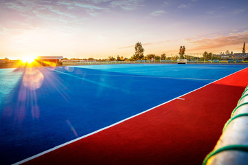 Fototapeta na wymiar Modern Astroturf / artificial grass hockey field in red and blue