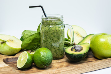 Fresh detox spinach smoothie with apples, avocado and lime.