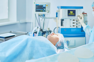 Several doctors surrounding patient on operation table during t