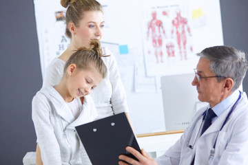 Little girl with her mother at a doctor on consultation