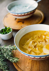 Delicious Chicken Noodle Soup on a wooden board with ingredients