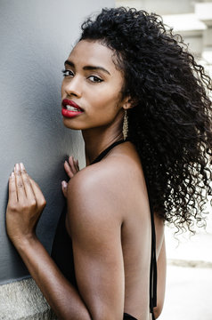 Black woman with red lips looking at camera