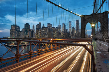 Light trails of passing cars and traffic on the Brooklyn Bridge in New York City