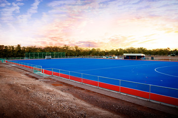 Modern Astroturf / artificial grass hockey field in red and blue