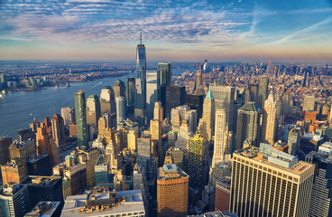 Aerial of the Manhattan financial district at golden hour, looking north towards the empire state...