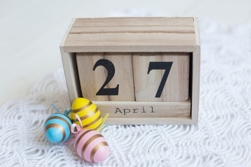 wooden calendar April 27 Easter, painted eggs