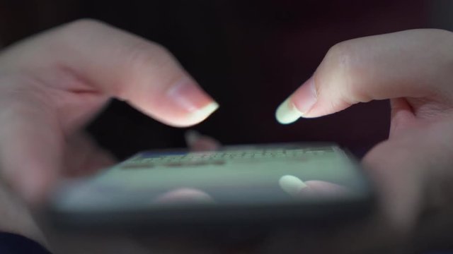 Close up woman hands texting message on mobile smart phone for business communication and chatting on social online at night