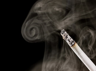 White smoke with cigarette isolated on black background