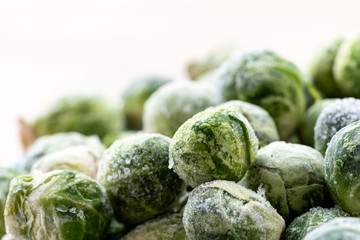 Fototapeta na wymiar A pile of frozen brussels sprouts close up.