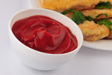 Fried chicken nuggets and parsley on an isolated gray background