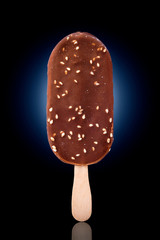 Beautiful ice cream with nuts on a black-blue background.