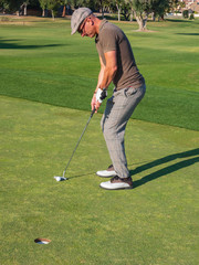 Fototapeta premium athletic and attractive man playing golf on a sunny day
