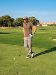 Fototapeta premium athletic and attractive man playing golf on a sunny day