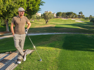 Fototapeta premium athletic and attractive man playing golf on a sunny day