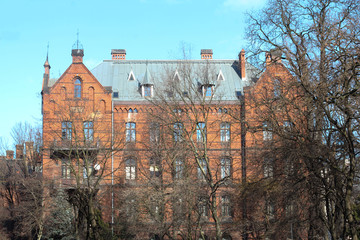 mystical castle, red brick building, red castle, creepy trees, creepy trees in front of the castle