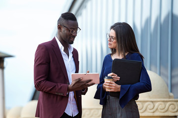 Businessman and woman having a meeting on a hotel terrace