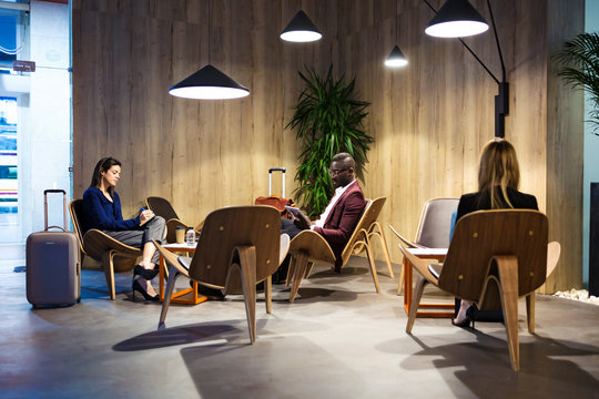 Business People Sitting In Hotel Lobby, Working